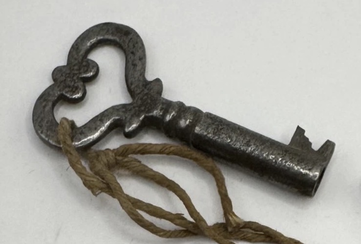 Detail view: key bow and hollow barrel shaft, showing patina and wear